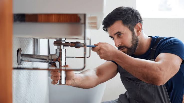 A verified professional servicing an AC unit